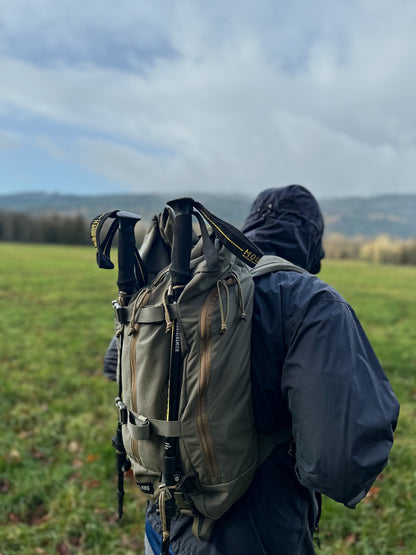 rainier roll top backpack with trekking poles ranger green